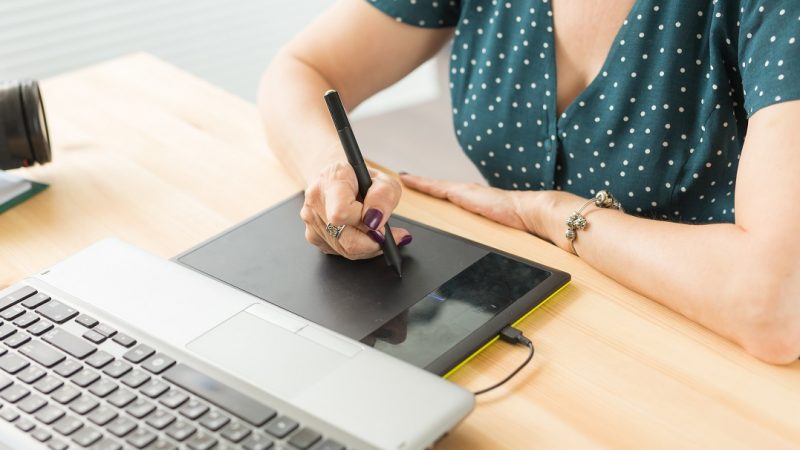 Office, graphic designer - Business woman hands holding digital tablet, drawing the sketch